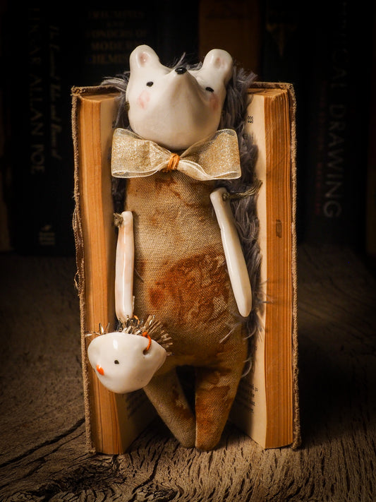 An adorable hand made porcelain and fabric fine art doll by Idania Salcido Danita Art. Perfect to hang as a delicate Christmas tree ornament, this fired ceramic mixed media artwork is unique. Each doll has a beautiful hand sculpted porcelain ceramic face and hand dyed fabric body with vintage accessories as home decor.