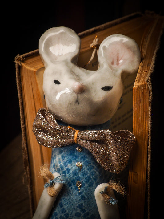 An adorable hand made porcelain and fabric fine art doll by Idania Salcido Danita Art. Perfect to hang as a delicate Christmas tree ornament, this fired ceramic mixed media artwork is unique. Each doll has a beautiful hand sculpted porcelain ceramic face and hand dyed fabric body with vintage accessories as home decor.