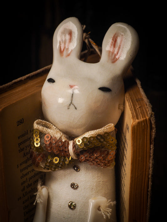 An adorable hand made porcelain and fabric fine art doll by Idania Salcido Danita Art. Perfect to hang as a delicate Christmas tree ornament, this fired ceramic mixed media artwork is unique. Each doll has a beautiful hand sculpted porcelain ceramic face and hand dyed fabric body with vintage accessories as home decor.