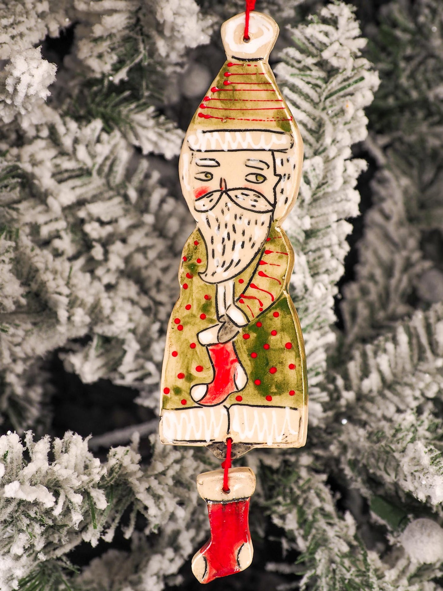 An original Christmas Holiday tree round glazed ceramic ornament handmade by Idania Salcido, the artist behind Danita Art. Glazed carved sgraffito stoneware, hand painted and decorated, it is illustrated by hand with snowmen, Christmas trees, Santa Claus, angels and snow balls and winter themes.