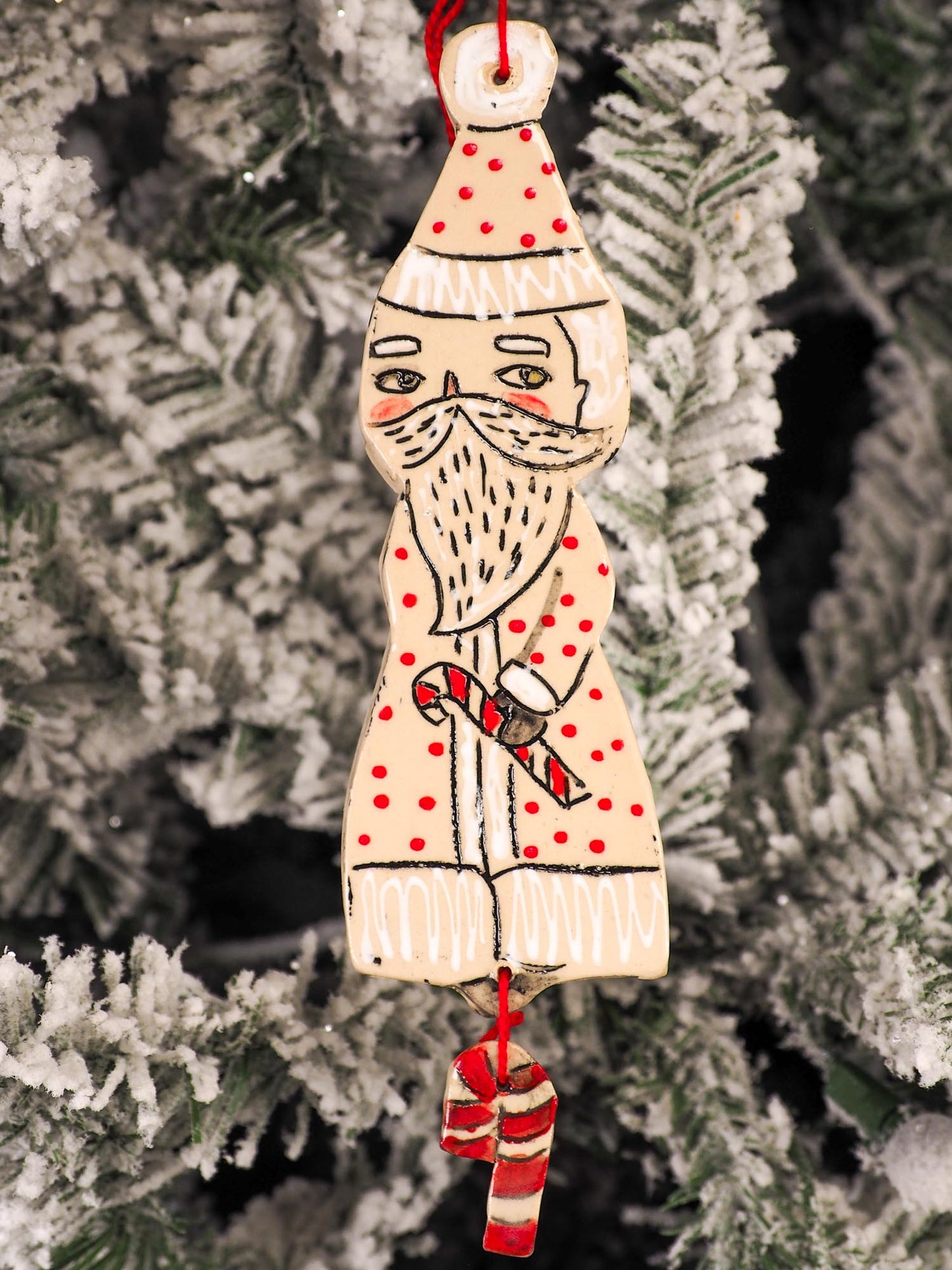 An original Christmas Holiday tree round glazed ceramic ornament handmade by Idania Salcido, the artist behind Danita Art. Glazed carved sgraffito stoneware, hand painted and decorated, it is illustrated by hand with snowmen, Christmas trees, Santa Claus, angels and snow balls and winter themes.