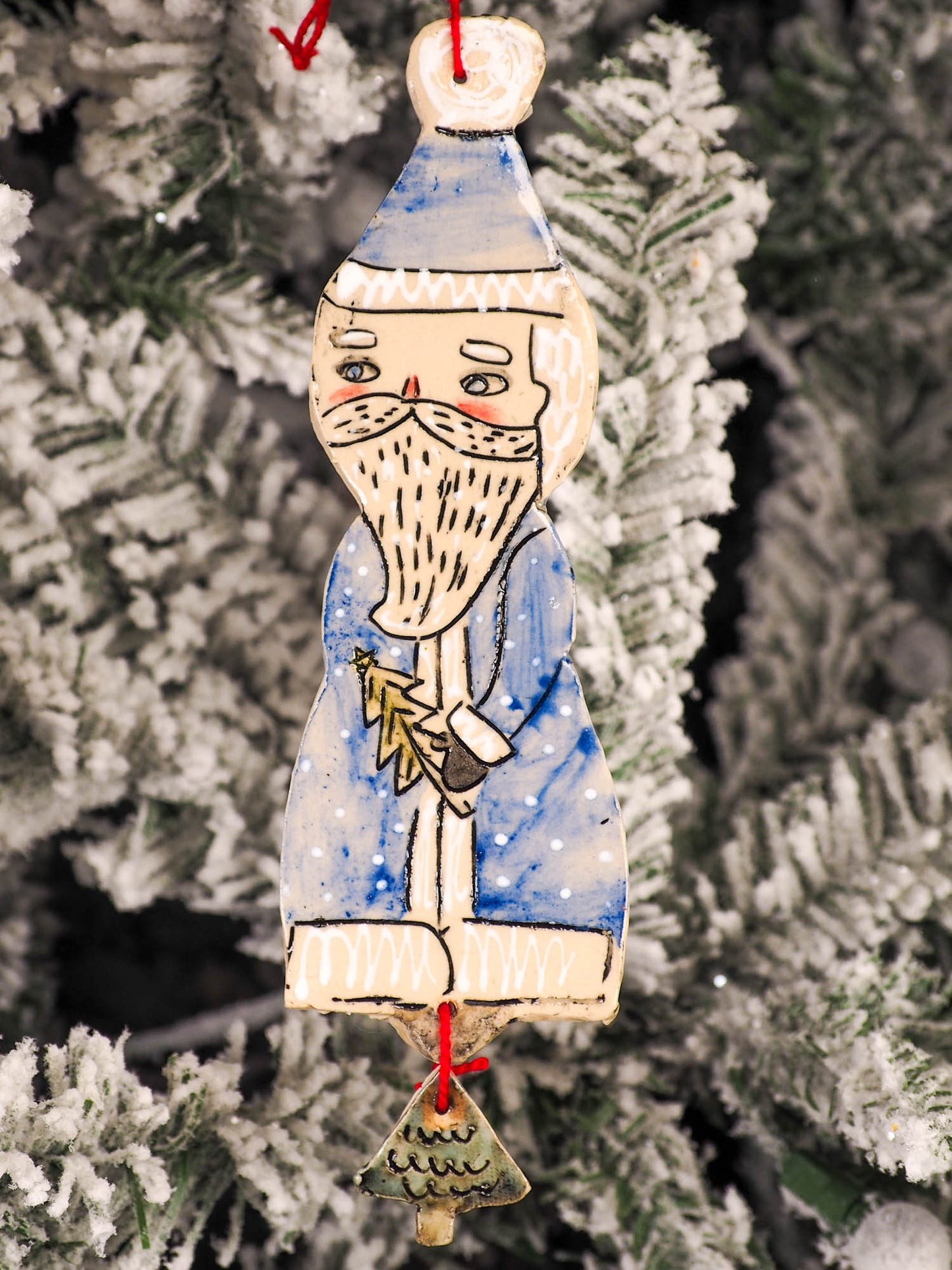 An original Christmas Holiday tree round glazed ceramic ornament handmade by Idania Salcido, the artist behind Danita Art. Glazed carved sgraffito stoneware, hand painted and decorated, it is illustrated by hand with snowmen, Christmas trees, Santa Claus, angels and snow balls and winter themes.