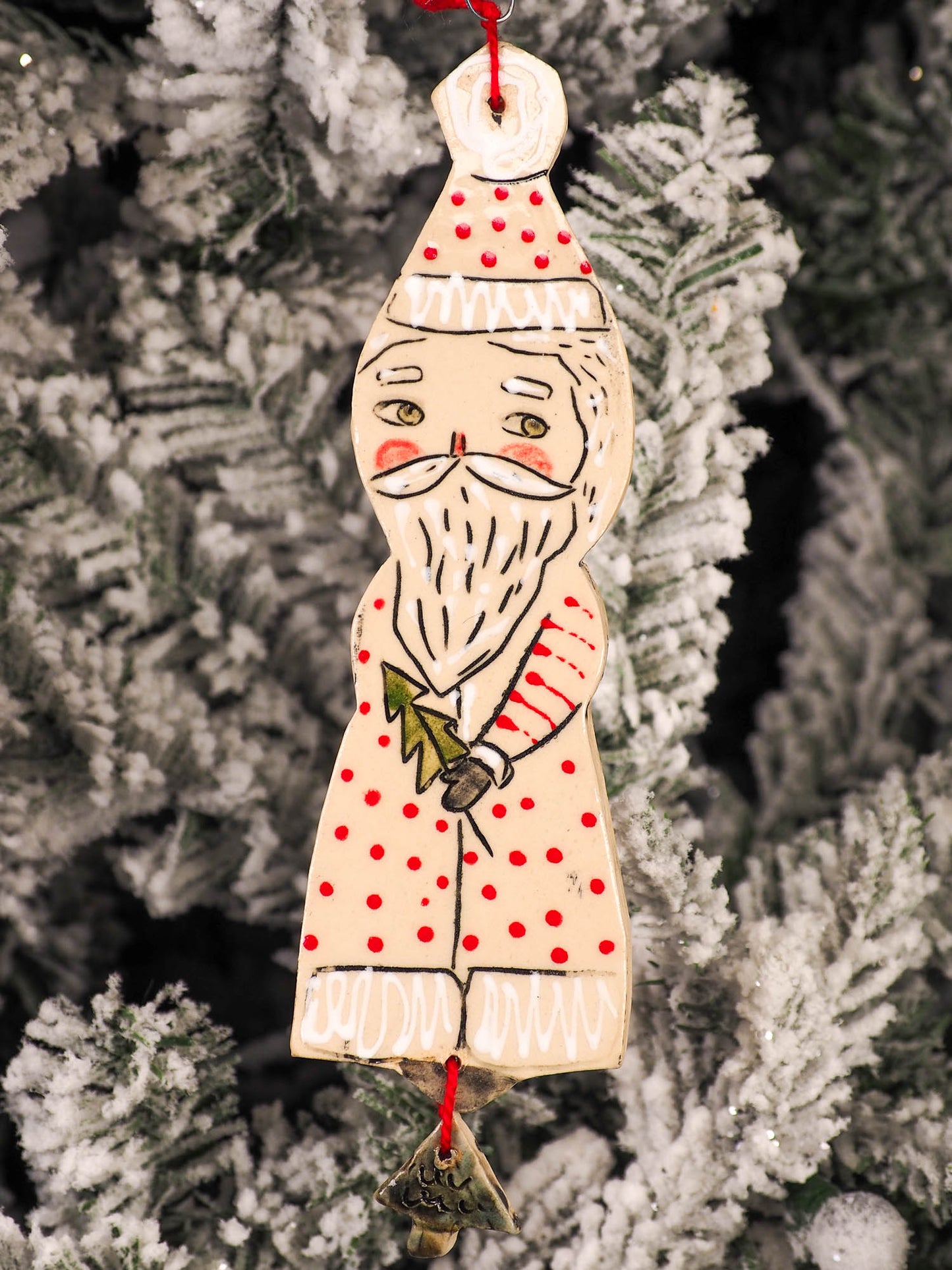 An original Christmas Holiday tree round glazed ceramic ornament handmade by Idania Salcido, the artist behind Danita Art. Glazed carved sgraffito stoneware, hand painted and decorated, it is illustrated by hand with snowmen, Christmas trees, Santa Claus, angels and snow balls and winter themes.