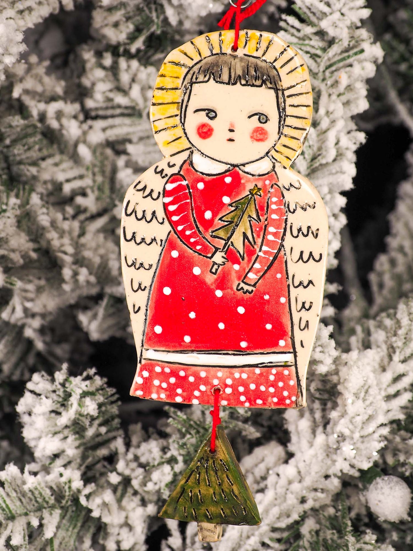 An original Christmas Holiday tree round glazed ceramic ornament handmade by Idania Salcido, the artist behind Danita Art. Glazed carved sgraffito stoneware, hand painted and decorated, it is illustrated by hand with snowmen, Christmas trees, Santa Claus, angels and snow balls and winter themes.