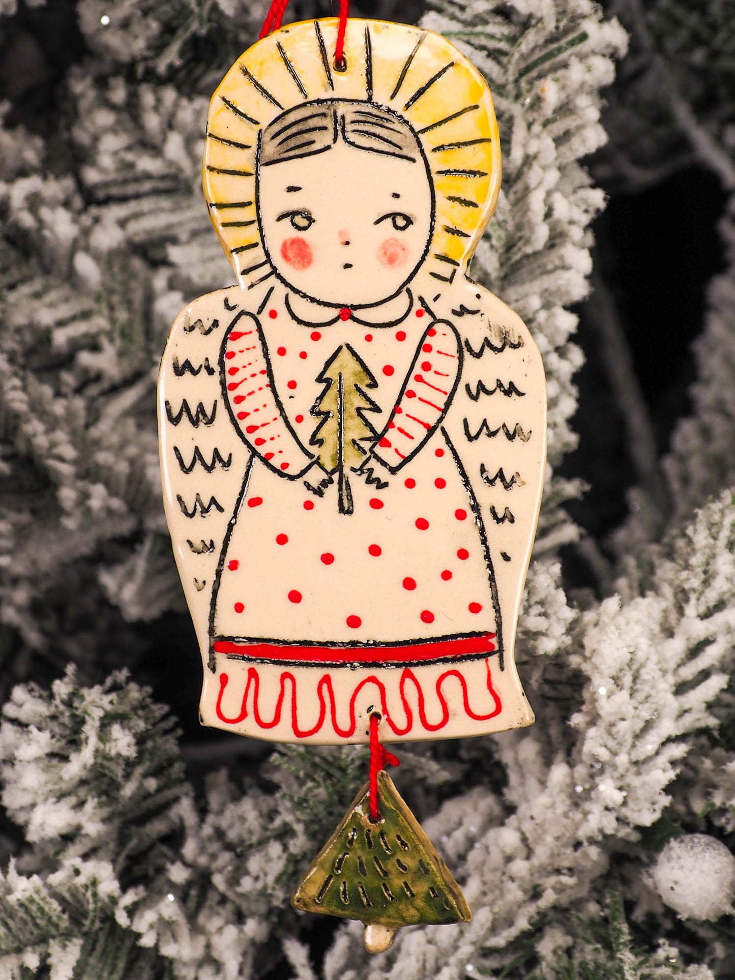 An original Christmas Holiday tree round glazed ceramic ornament handmade by Idania Salcido, the artist behind Danita Art. Glazed carved sgraffito stoneware, hand painted and decorated, it is illustrated by hand with snowmen, Christmas trees, Santa Claus, angels and snow balls and winter themes.