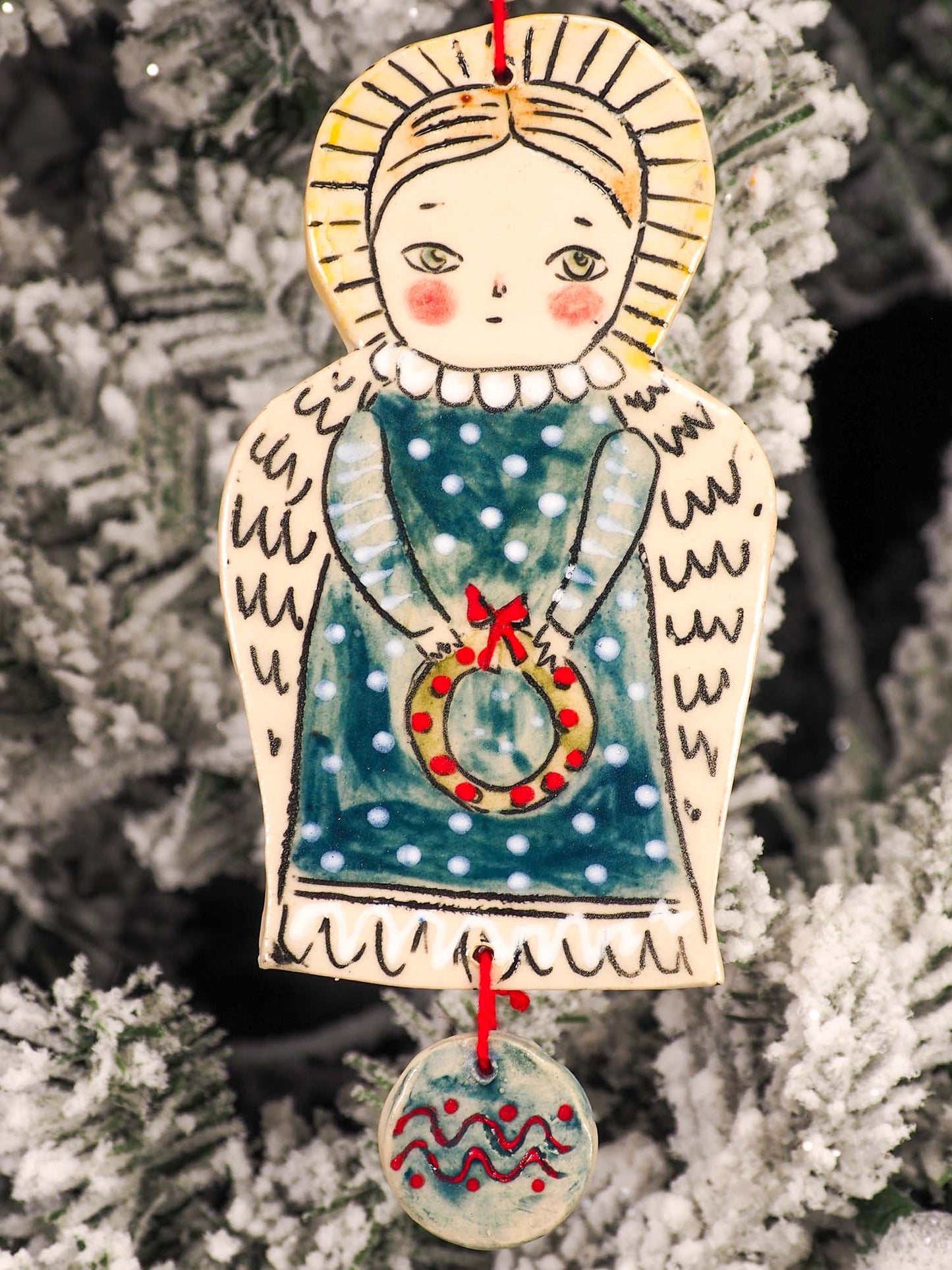 An original Christmas Holiday tree round glazed ceramic ornament handmade by Idania Salcido, the artist behind Danita Art. Glazed carved sgraffito stoneware, hand painted and decorated, it is illustrated by hand with snowmen, Christmas trees, Santa Claus, angels and snow balls and winter themes.