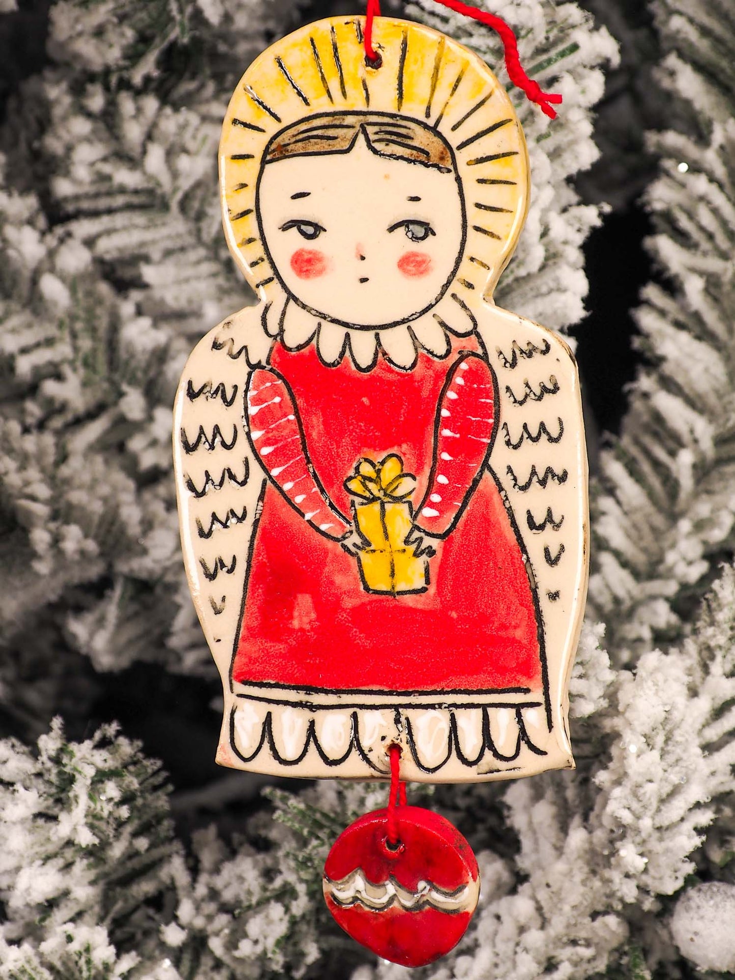 An original Christmas Holiday tree round glazed ceramic ornament handmade by Idania Salcido, the artist behind Danita Art. Glazed carved sgraffito stoneware, hand painted and decorated, it is illustrated by hand with snowmen, Christmas trees, Santa Claus, angels and snow balls and winter themes.