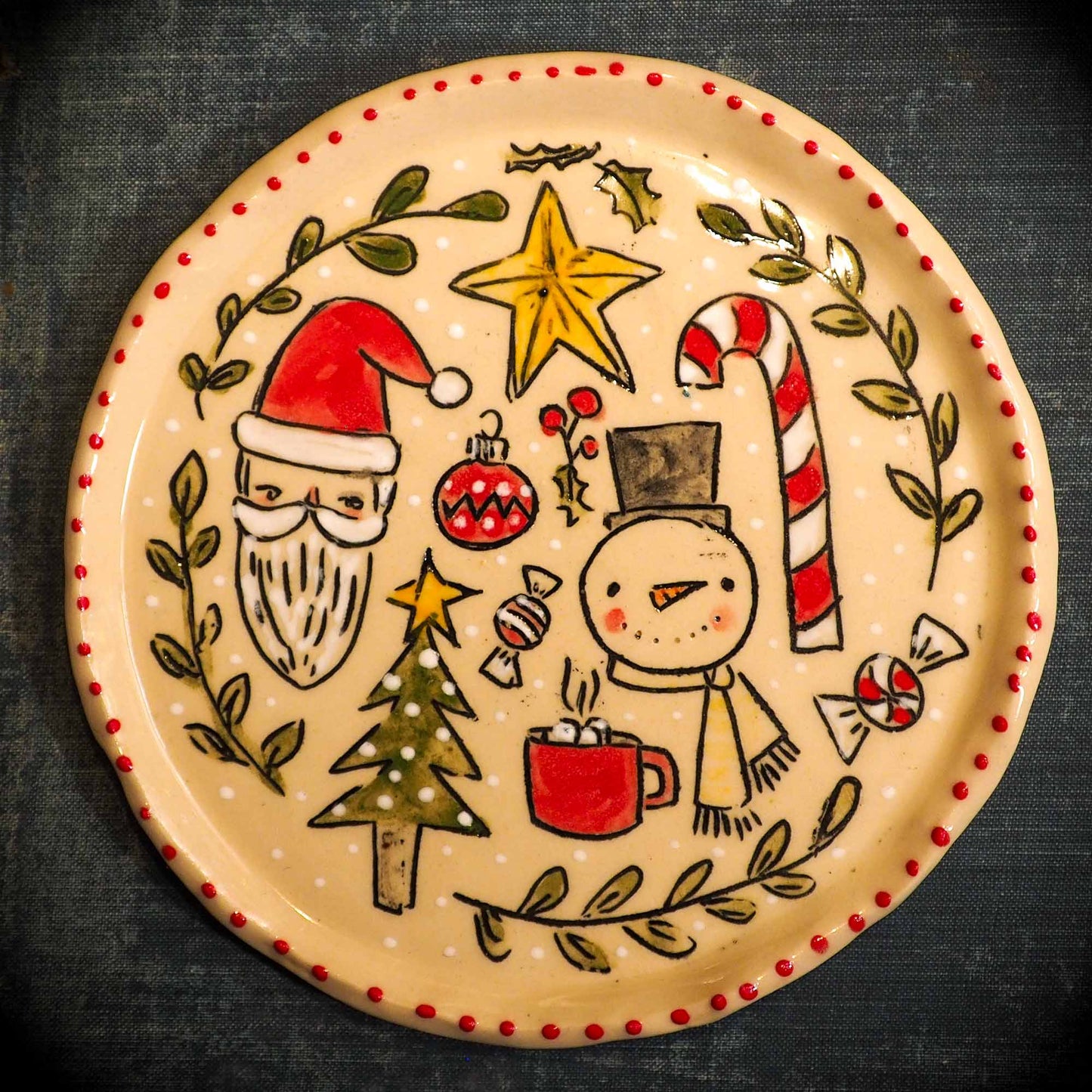 An original Christmas Holiday cake dinner dessert plate round glazed ceramic dinnerware handmade by Idania Salcido, the artist behind Danita Art. Glazed carved sgraffito stoneware, hand painted and decorated, it is illustrated by hand with snowmen, Christmas trees, Santa Claus, angels and snowballs and winter themes.