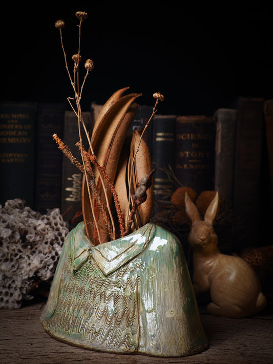 Using hand pinching techniques in of a kind fire glazed ceramics, Idania Salcido, the artist behind Danita Art, sculpted glazed ceramic clay vase containers and flower pots in the shape of vintage blouses. Beautiful accents for your dinner table, showcase or anywhere you want to remind you of family and love.