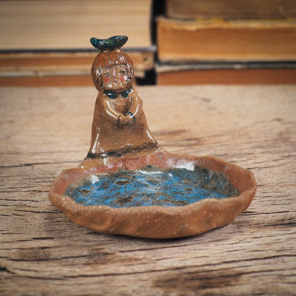 An original handmade ceramic girl with a bird on her head by Idania Salcido AKA Danita Art. She is perfect for storing jewelry, rings, and keys in her blue tray