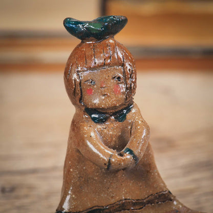 An original handmade ceramic girl with a bird on her head by Idania Salcido AKA Danita Art. She is perfect for storing jewelry, rings, and keys in her blue tray