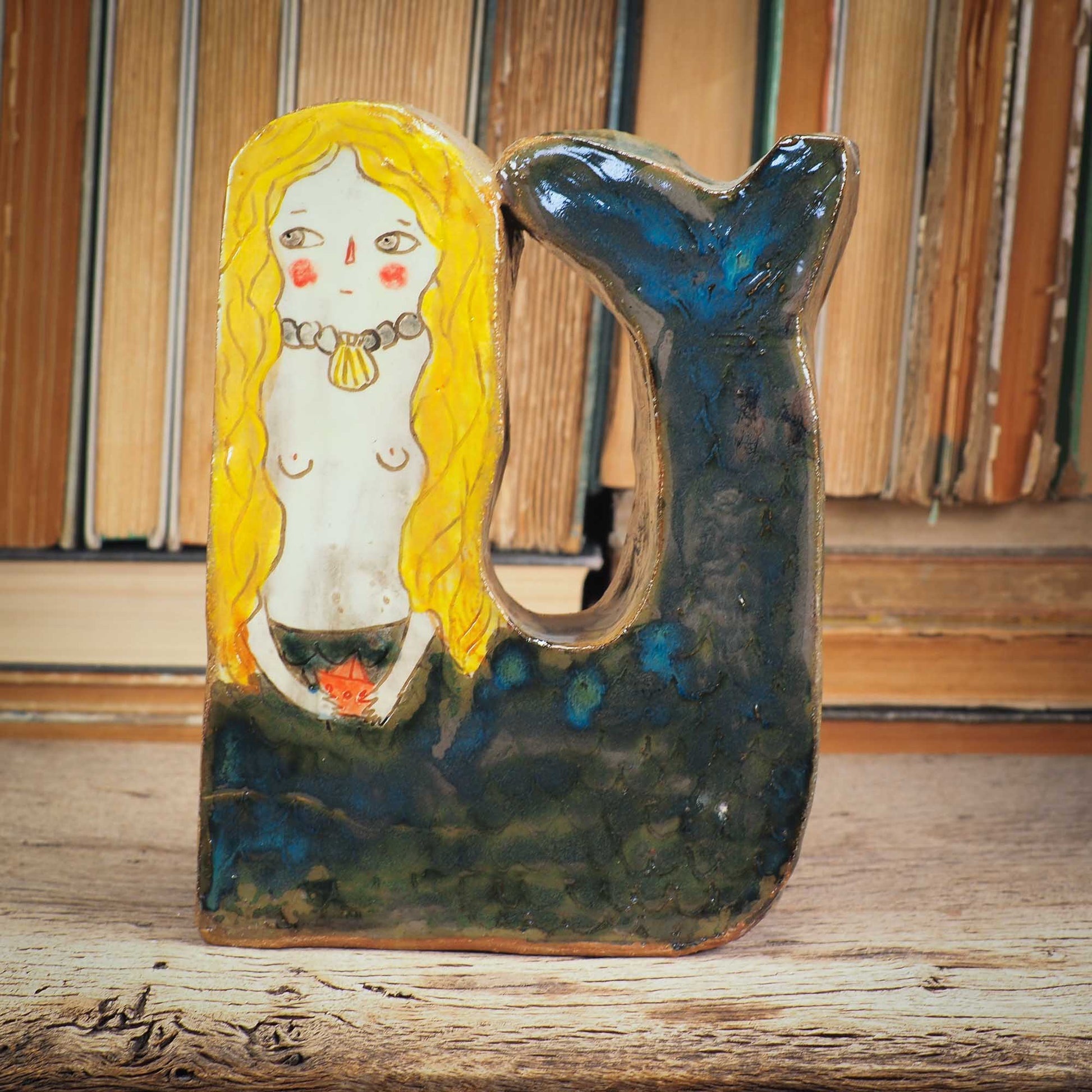 This little mermaid is a little shy, but she is beautiful and perfect to live on a shelf where she can command her realm An original sculpture by Idania Salcido