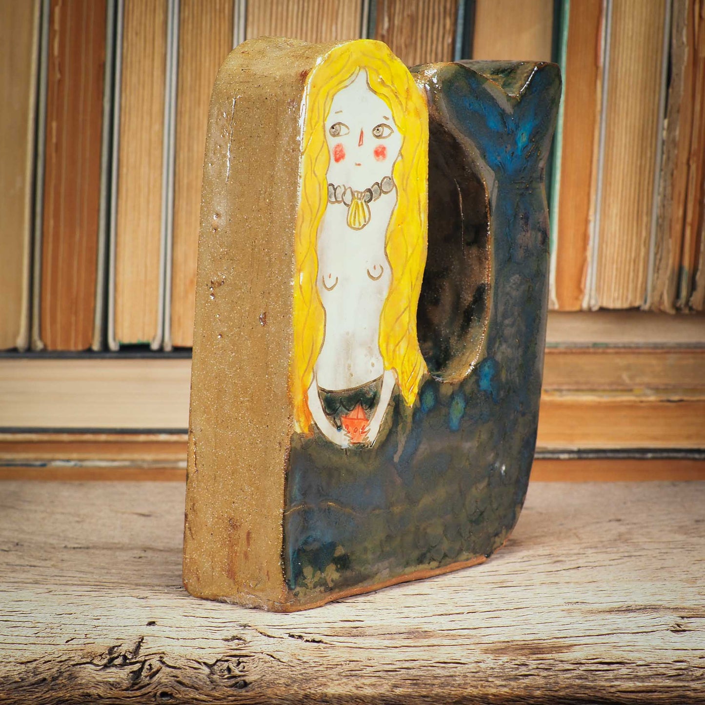 This little mermaid is a little shy, but she is beautiful and perfect to live on a shelf where she can command her realm An original sculpture by Idania Salcido