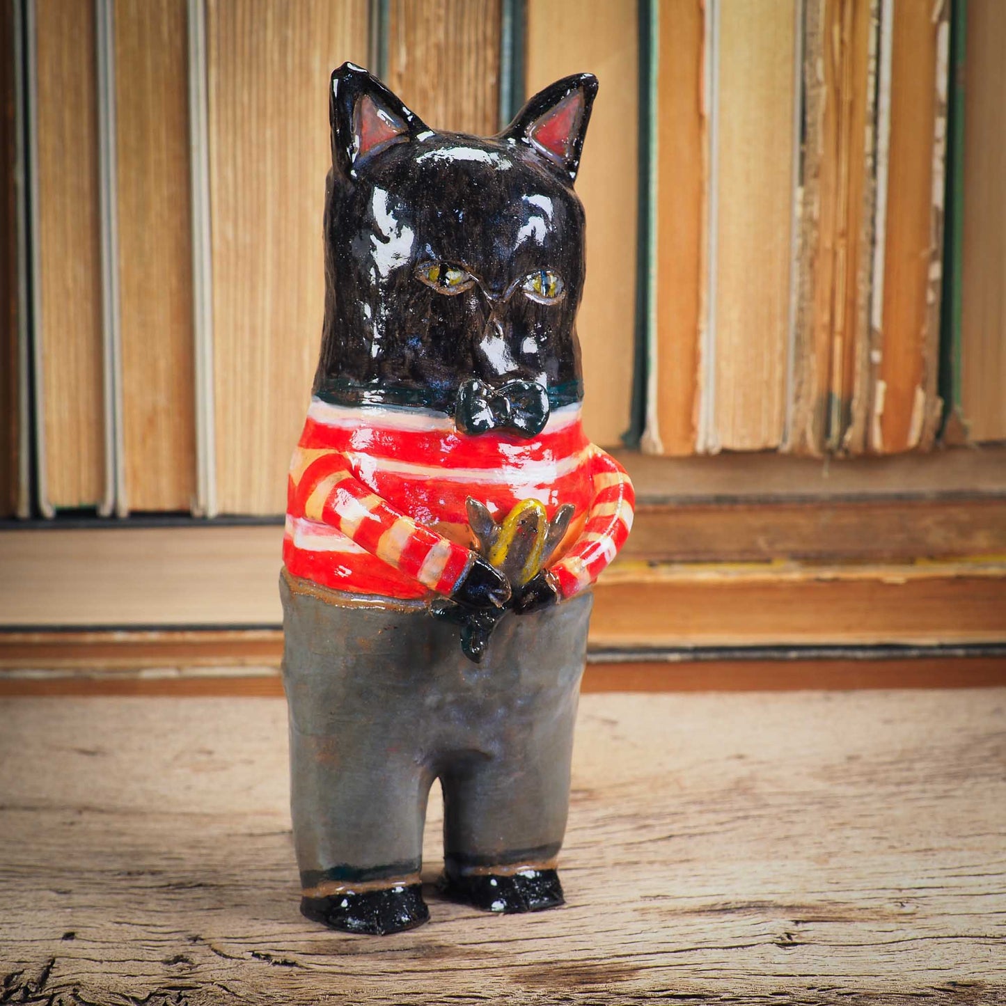A handmade ceramic cat that loves fish... and mermaids! He is holding a cute little blond mermaid in his paws. Original ceramic sculpture by Idania Salcido.