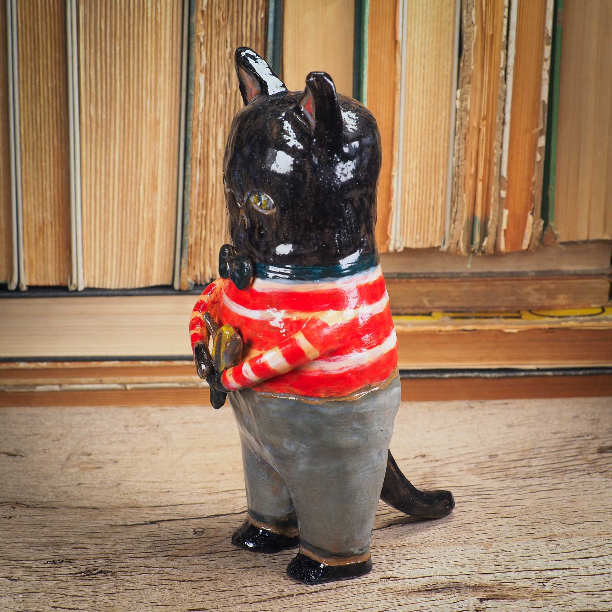 A handmade ceramic cat that loves fish... and mermaids! He is holding a cute little blond mermaid in his paws. Original ceramic sculpture by Idania Salcido.