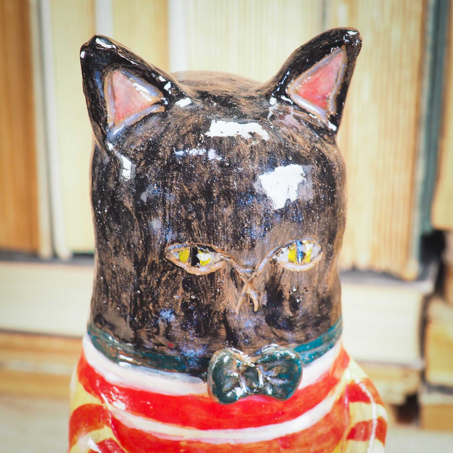 A handmade ceramic cat that loves fish... and mermaids! He is holding a cute little blond mermaid in his paws. Original ceramic sculpture by Idania Salcido.