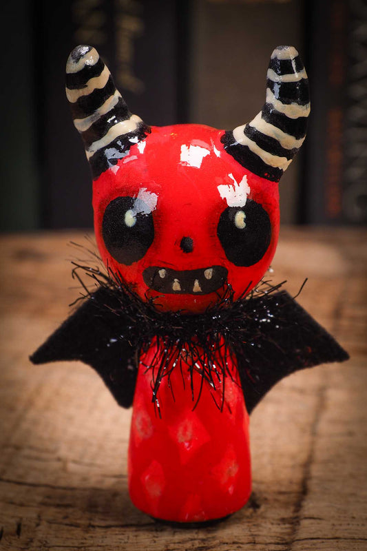 Small Halloween mini kokeshi art doll figurine with sculpted horned red devil head, striped horns, black wings and scarf. Made by Idania Salcido, Danita Art.