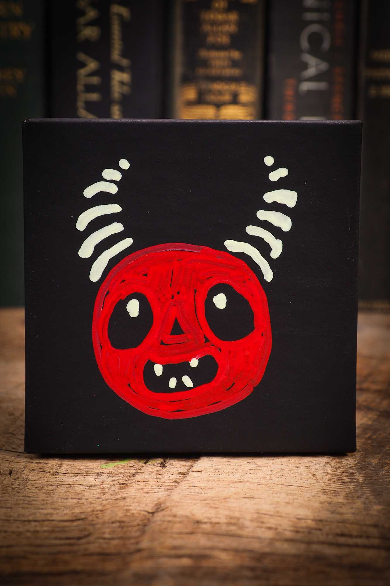 Small Halloween mini kokeshi art doll figurine with sculpted horned red devil head, striped horns, black wings and scarf. Made by Idania Salcido, Danita Art.