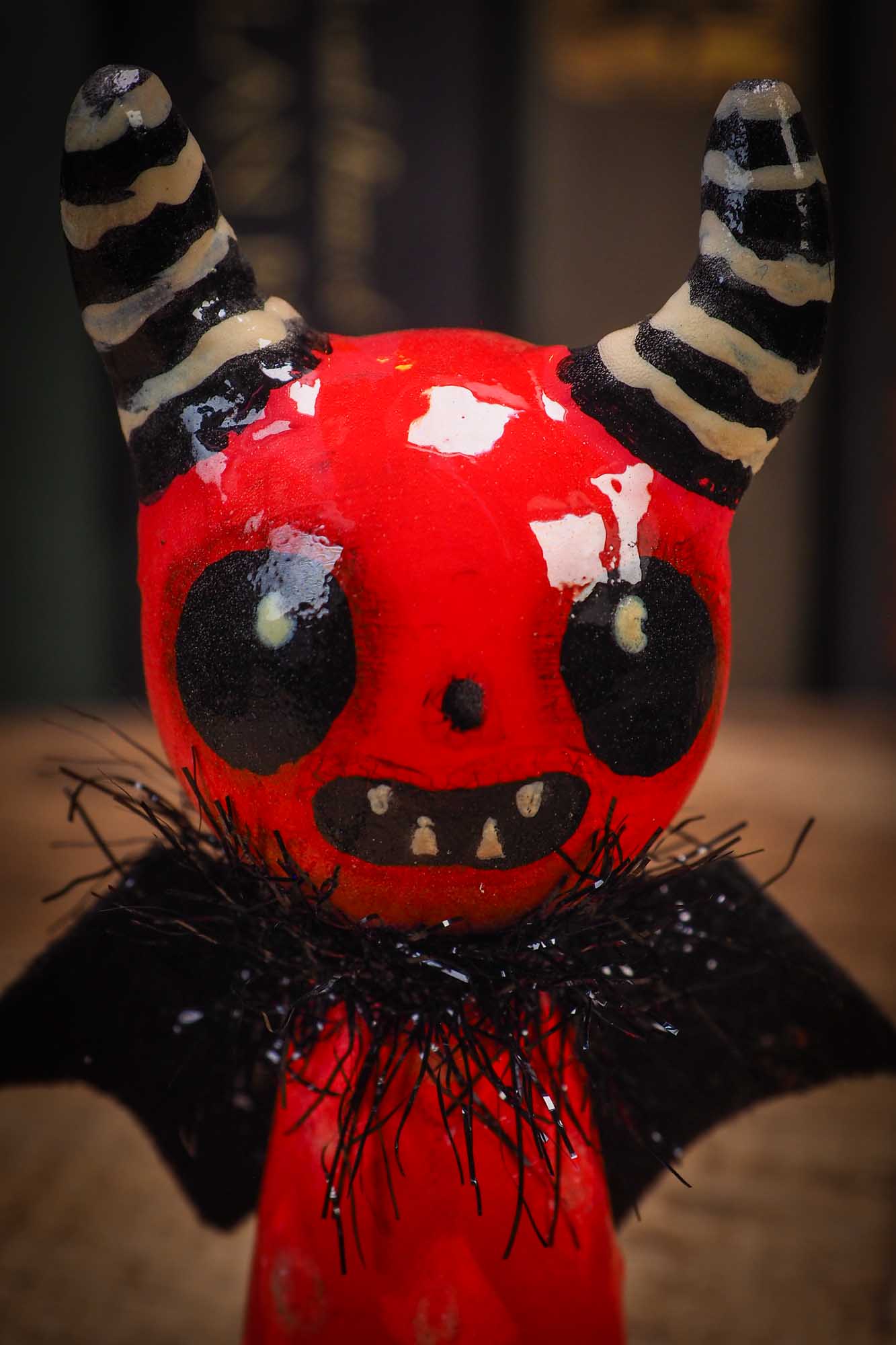 Small Halloween mini kokeshi art doll figurine with sculpted horned red devil head, striped horns, black wings and scarf. Made by Idania Salcido, Danita Art.