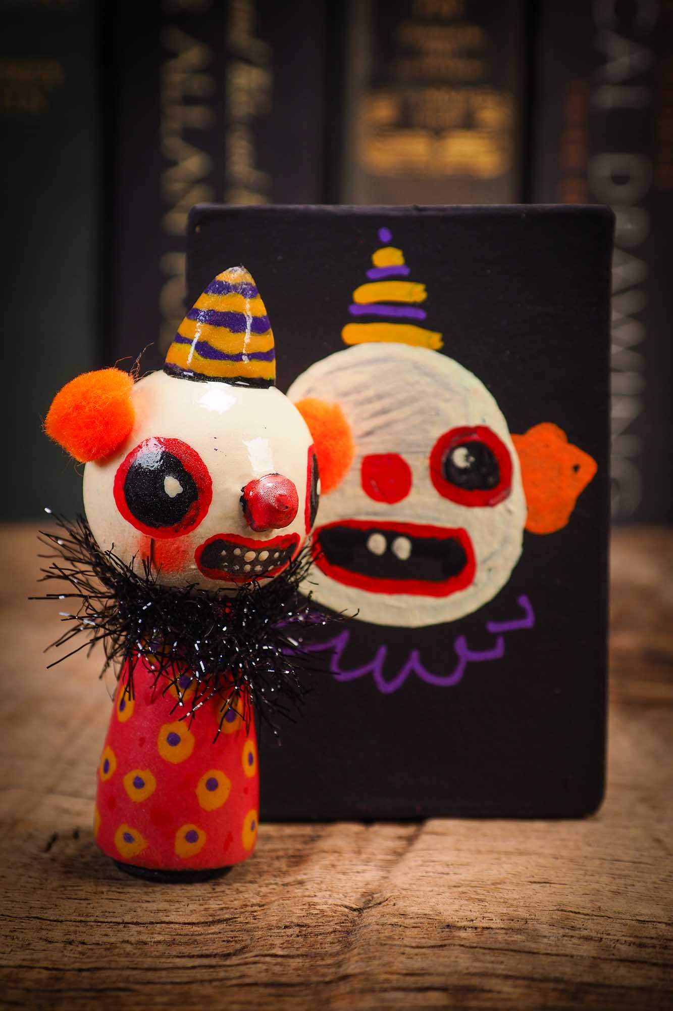 Small Halloween mini kokeshi art doll evil it pennywise clown figurine with painted makeup, orange polka dot body and party hat. Made by Idania Salcido, Danita Art.