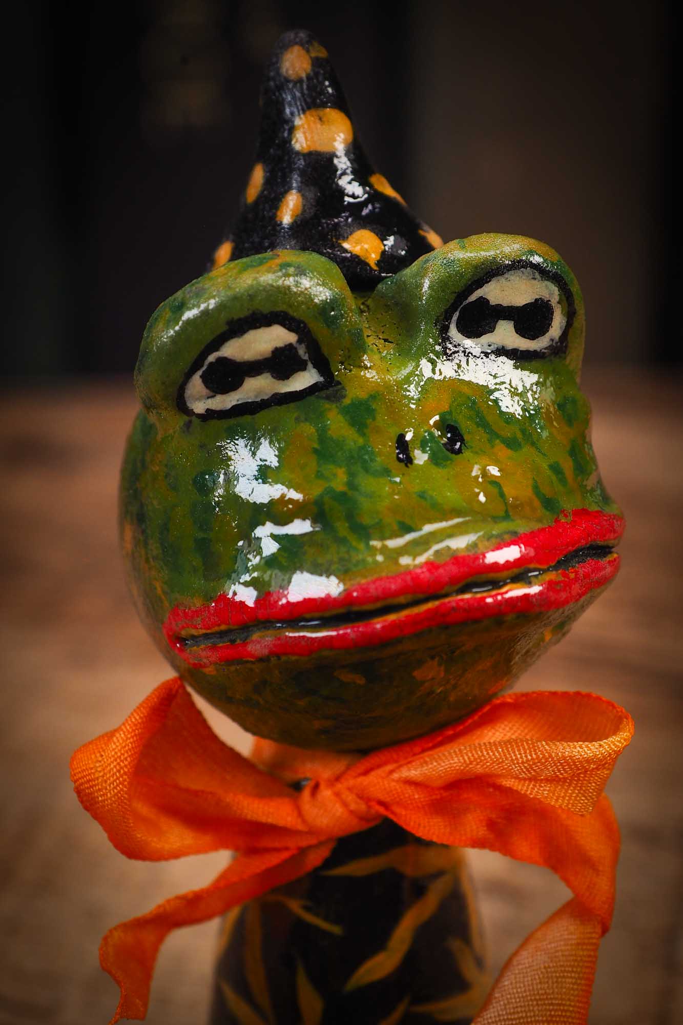 Small Halloween mini kokeshi art doll magic green toad wizard figurine with painted star body, orange silk bow. Made by Idania Salcido, Danita Art.