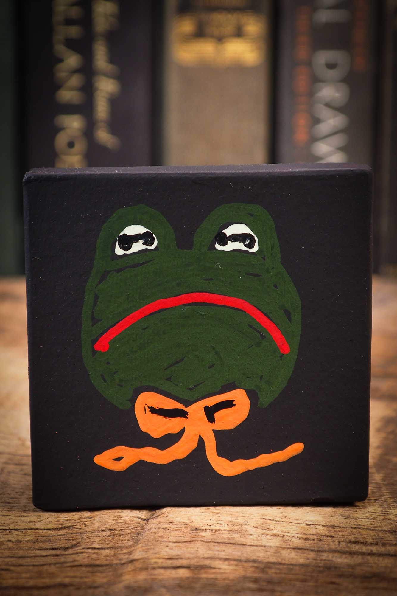 Small Halloween mini kokeshi art doll magic green toad wizard figurine with painted star body, orange silk bow. Made by Idania Salcido, Danita Art.