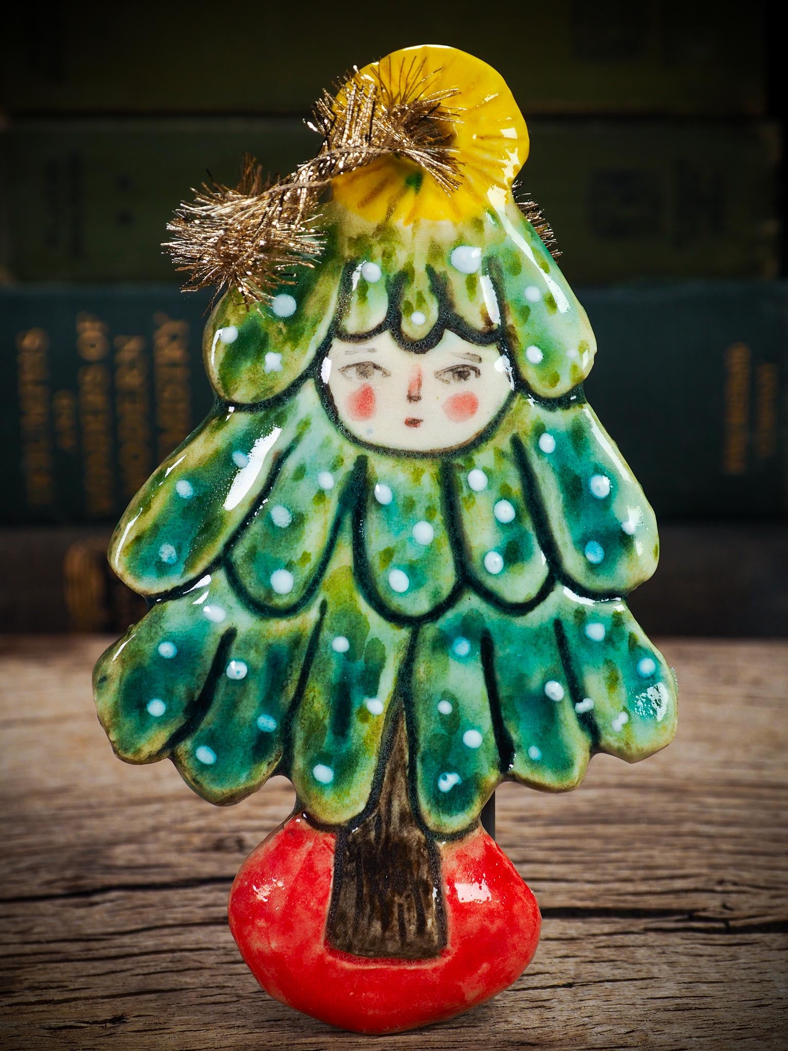 Handmade ceramic Christmas tree figure ornament with painted face and snowy details, created by Idania Salcido Danita Art for holiday decoration or gifting.
