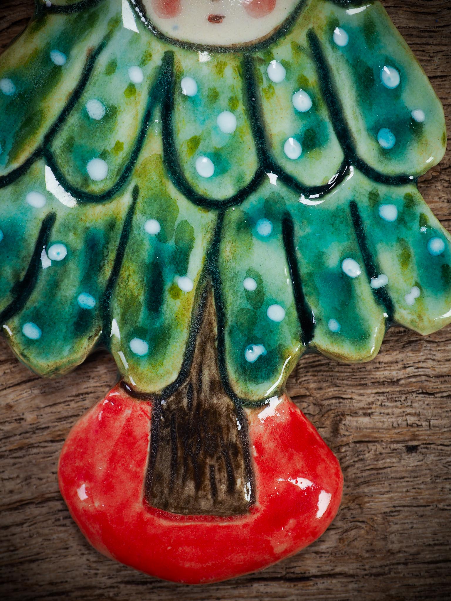 Handmade ceramic Christmas tree figure ornament with painted face and snowy details, created by Idania Salcido Danita Art for holiday decoration or gifting.
