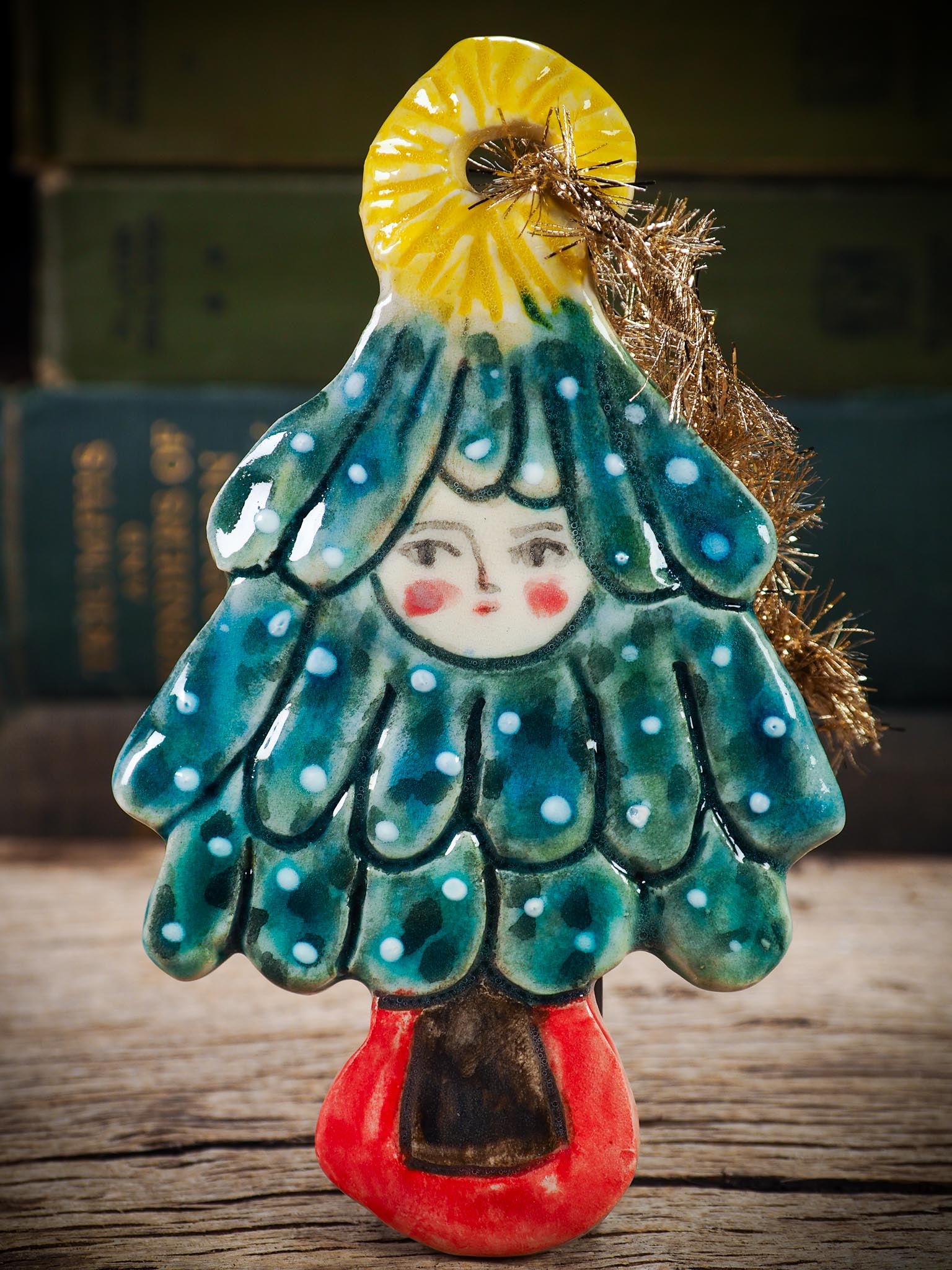 Handmade ceramic Christmas tree figure ornament with painted face and snowy details, created by Idania Salcido Danita Art for holiday decoration or gifting.