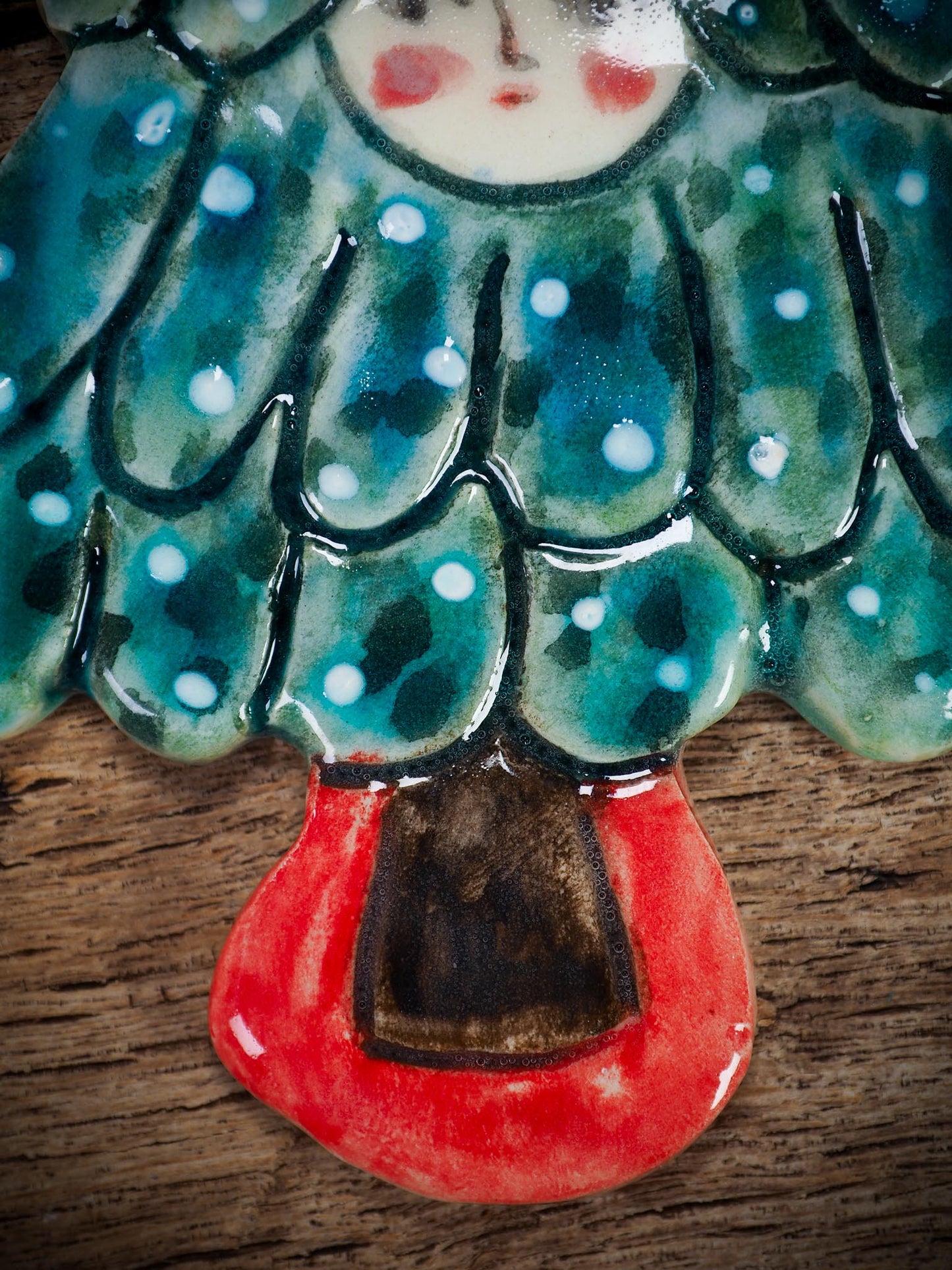 Handmade ceramic Christmas tree figure ornament with painted face and snowy details, created by Idania Salcido Danita Art for holiday decoration or gifting.