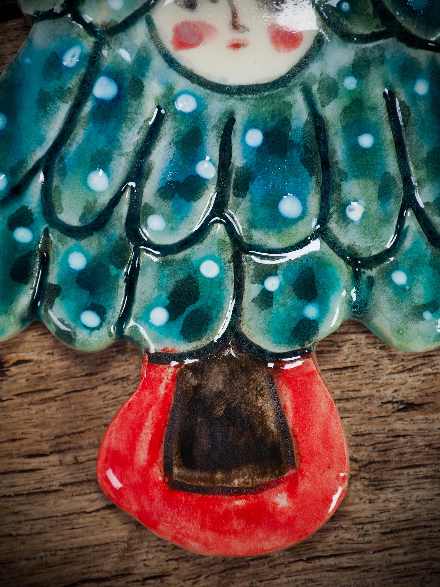 Handmade ceramic Christmas tree figure ornament with painted face and snowy details, created by Idania Salcido Danita Art for holiday decoration or gifting.