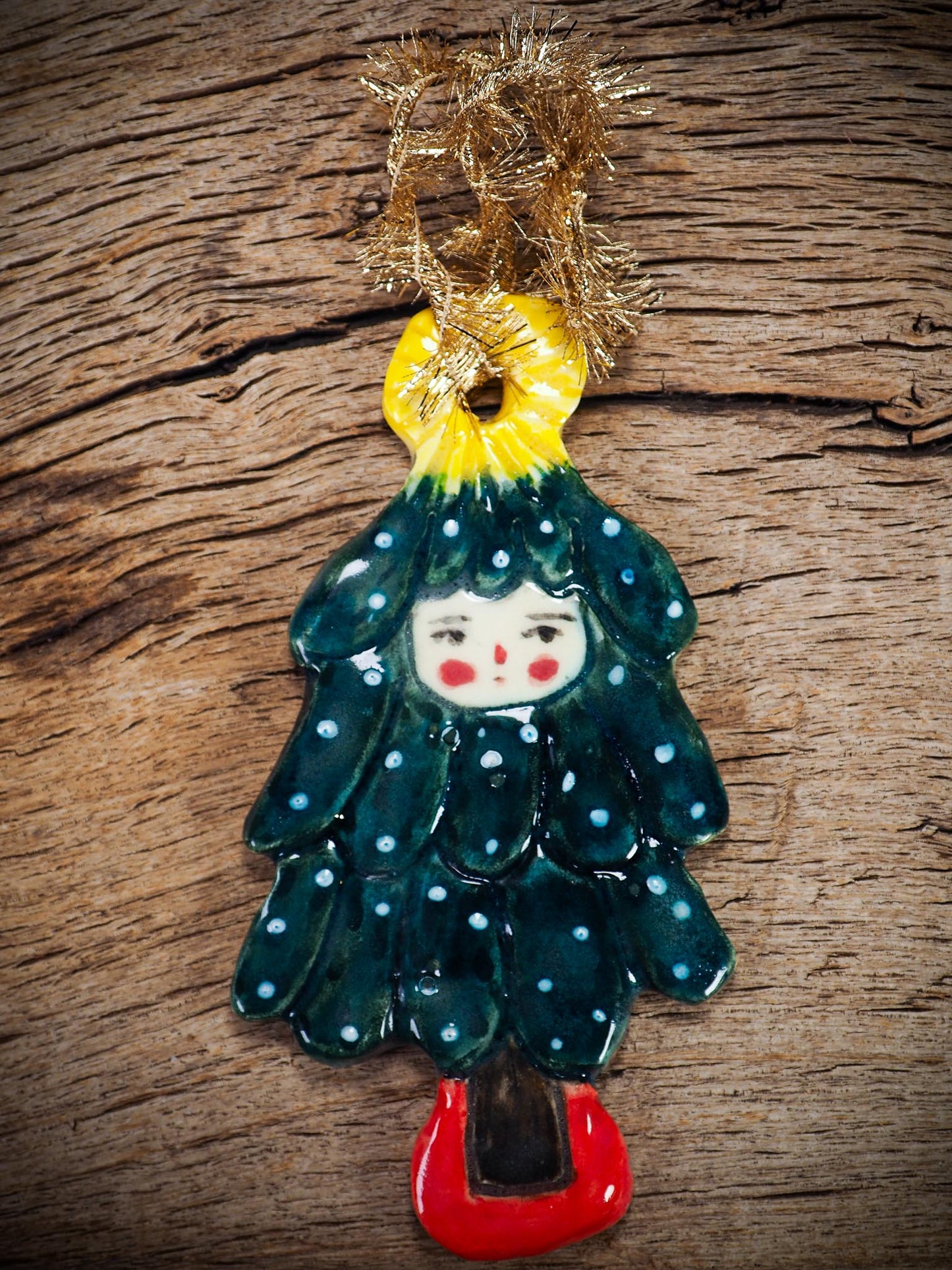 Handmade ceramic Christmas tree figure ornament with painted face and snowy details, created by Idania Salcido Danita Art for holiday decoration or gifting.