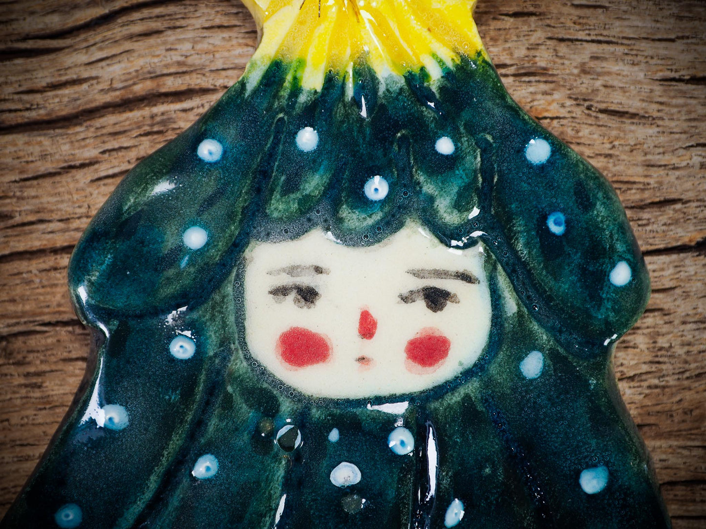 Handmade ceramic Christmas tree figure ornament with painted face and snowy details, created by Idania Salcido Danita Art for holiday decoration or gifting.