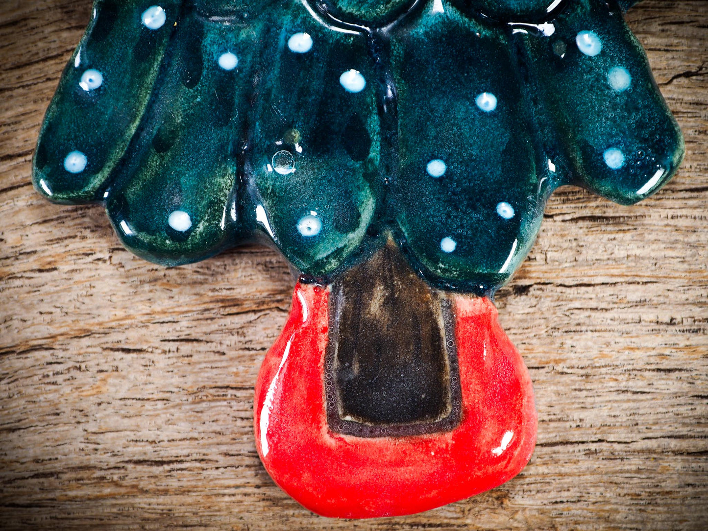 Handmade ceramic Christmas tree figure ornament with painted face and snowy details, created by Idania Salcido Danita Art for holiday decoration or gifting.