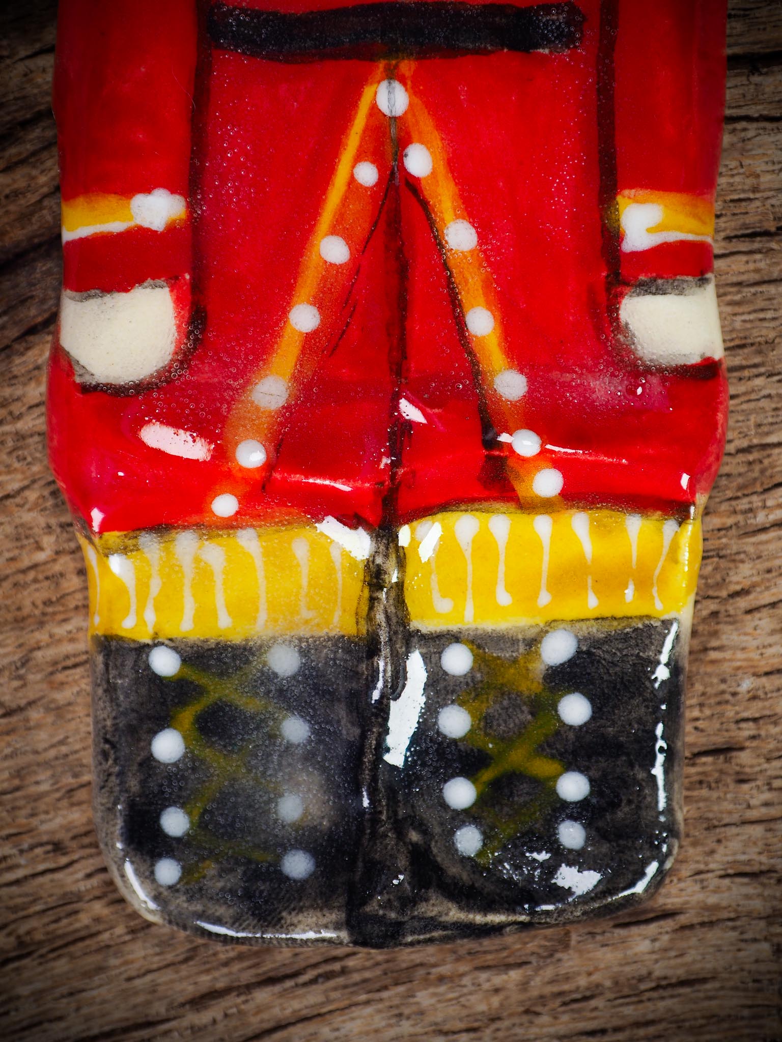 Handmade ceramic nutcracker ornament with red uniform and ribbon, created by Idania Salcido Danita Art for Christmas decoration or gifting.