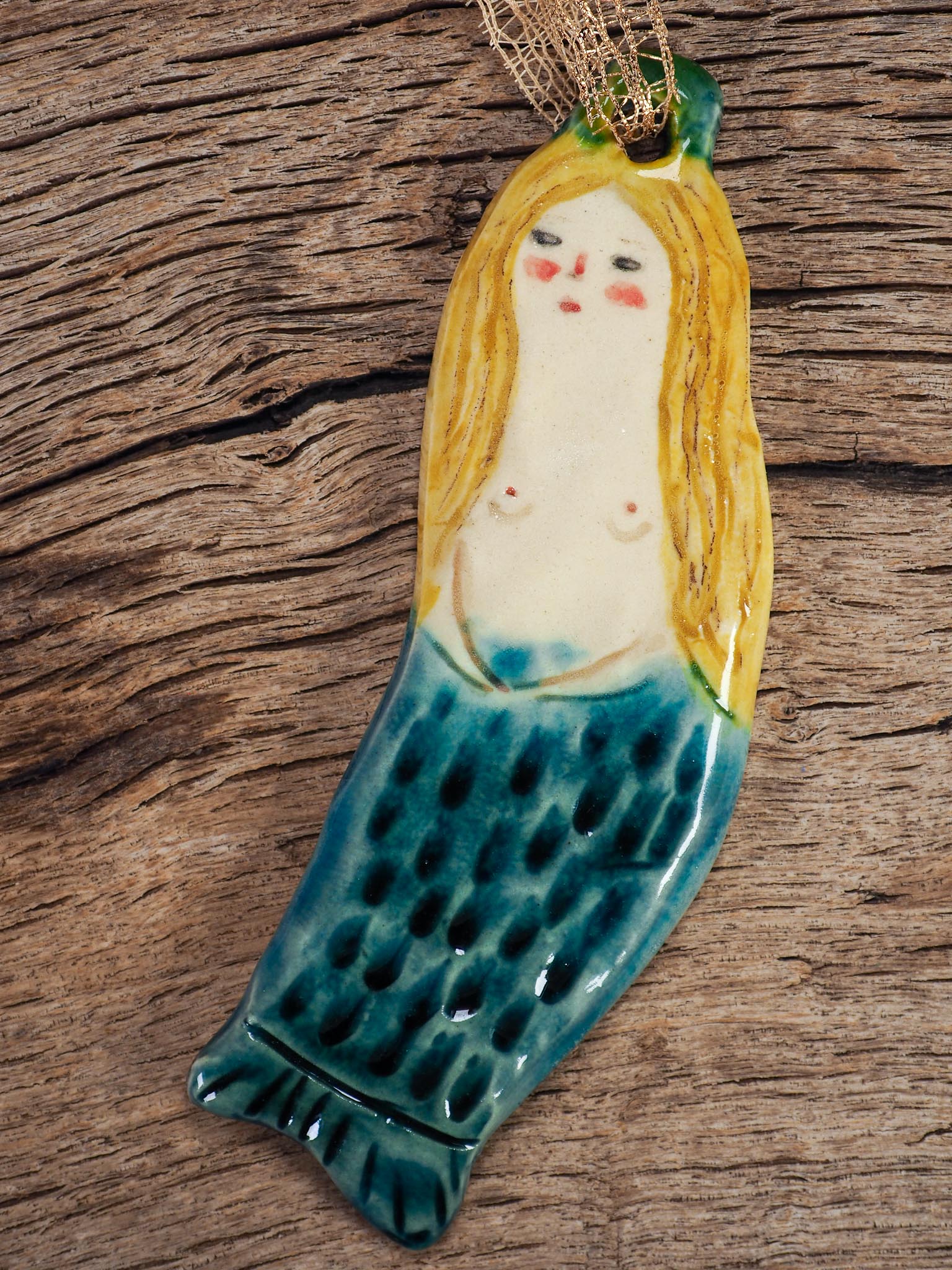 Handmade ceramic mermaid ornament with golden hair and blue-green tail, created by Idania Salcido aka Danita Art for holiday decorating or gifting.