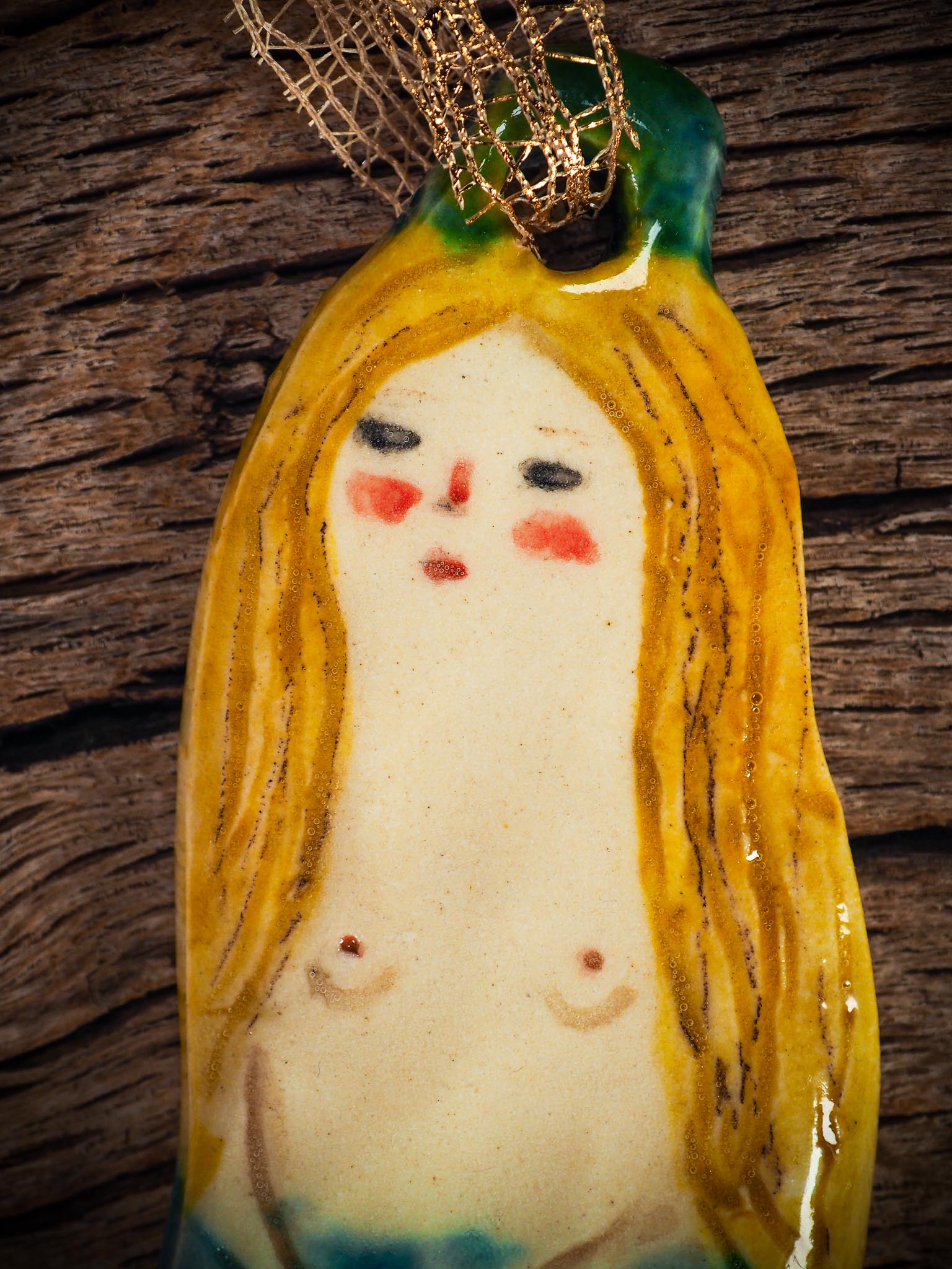 Handmade ceramic mermaid ornament with golden hair and blue-green tail, created by Idania Salcido aka Danita Art for holiday decorating or gifting.