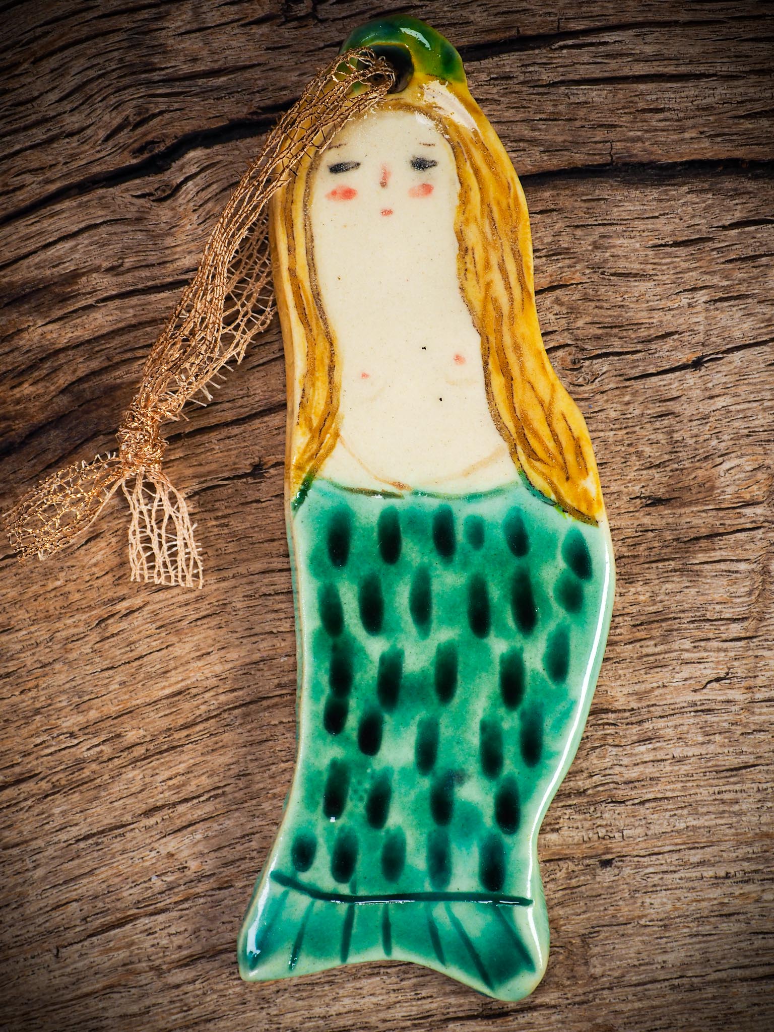 Handmade ceramic mermaid ornament with golden hair and blue-green tail, created by Idania Salcido aka Danita Art for holiday decorating or gifting.