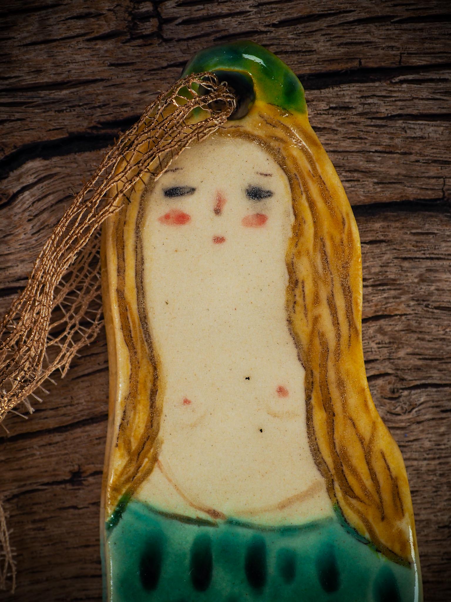 Handmade ceramic mermaid ornament with golden hair and blue-green tail, created by Idania Salcido aka Danita Art for holiday decorating or gifting.