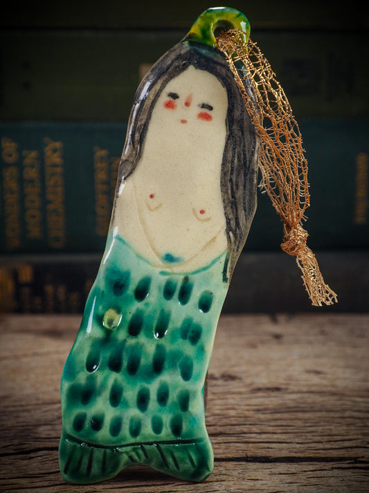 Handmade ceramic mermaid ornament with golden hair and blue-green tail, created by Idania Salcido aka Danita Art for holiday decorating or gifting.