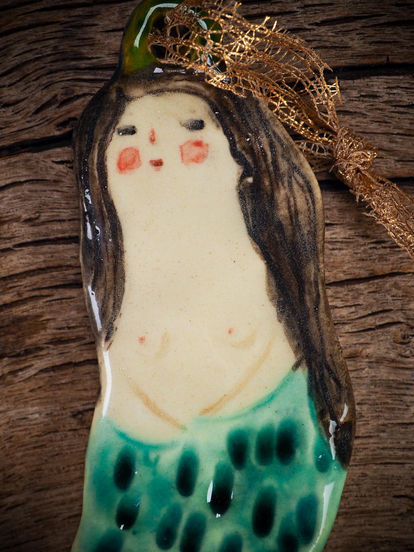 Handmade ceramic mermaid ornament with golden hair and blue-green tail, created by Idania Salcido aka Danita Art for holiday decorating or gifting.