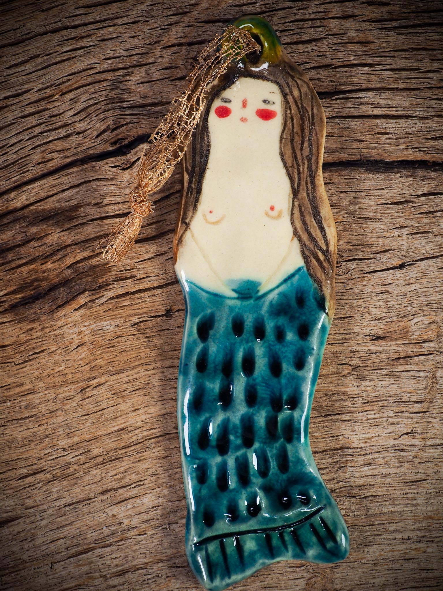 Handmade ceramic mermaid ornament with golden hair and blue-green tail, created by Idania Salcido aka Danita Art for holiday decorating or gifting.