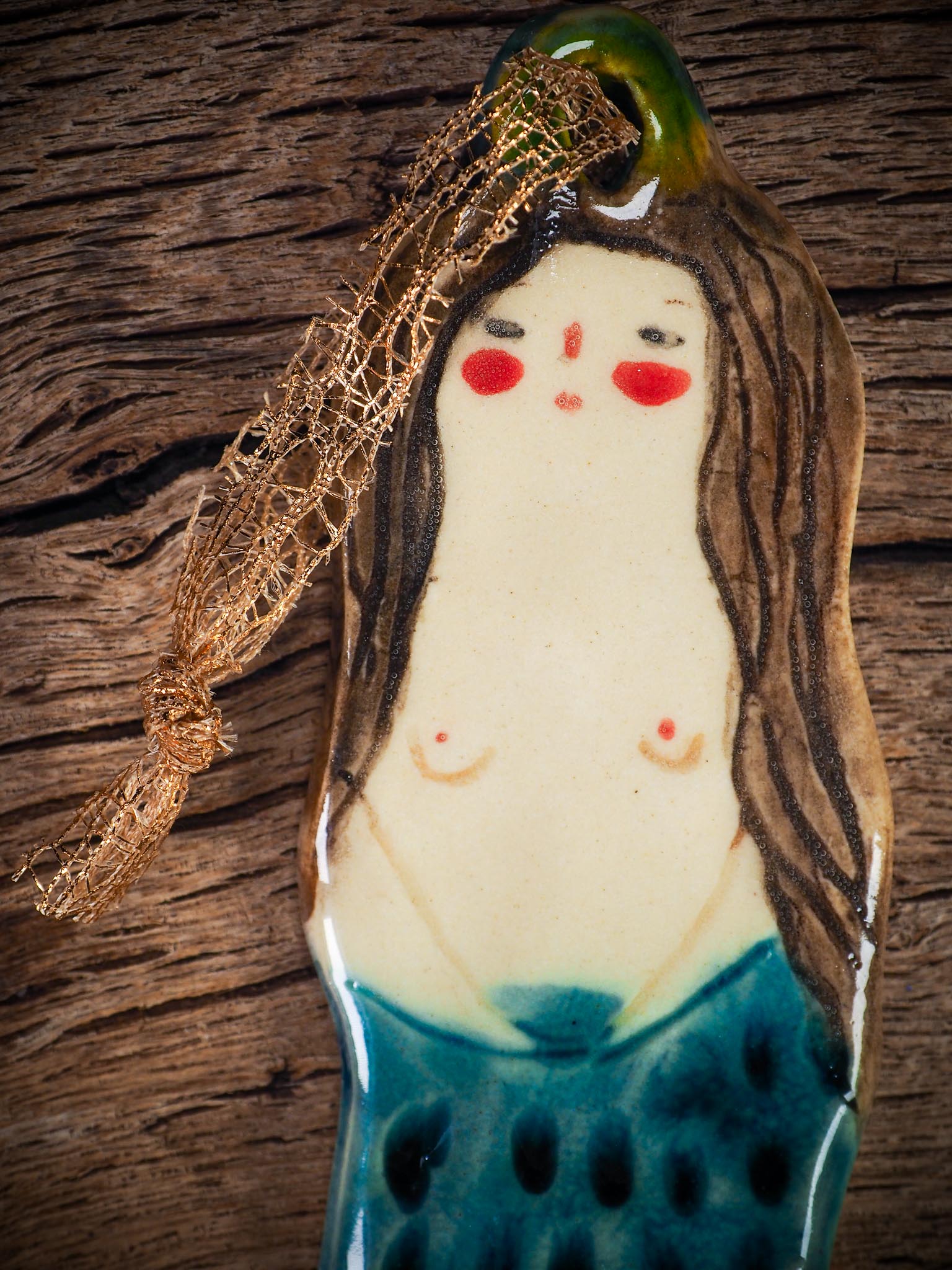 Handmade ceramic mermaid ornament with golden hair and blue-green tail, created by Idania Salcido aka Danita Art for holiday decorating or gifting.