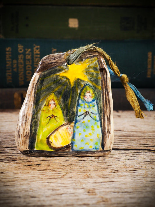 Handmade ceramic nativity ornament with painted figures and guiding star, created by Idania Salcido aka Danita Art for Christmas decoration or gifting.
