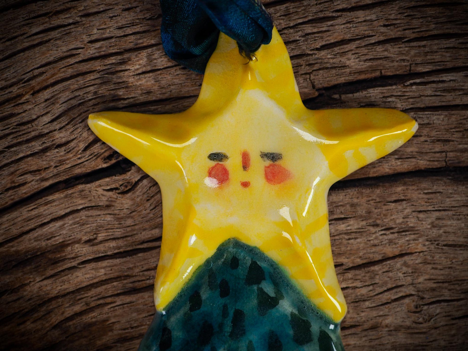 Handmade ceramic star figure ornament with painted face and blue-green gown, created by Idania Salcido Danita Art for Christmas decorating or gifting.