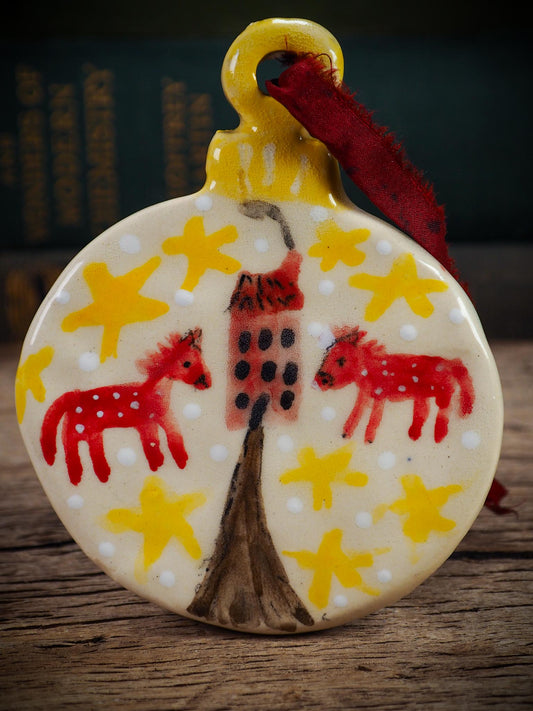 Handmade ceramic folk animals ornament with red animals, yellow stars, and small house, created by Idania Salcido aka Danita Art for Christmas decorating or gifting.
