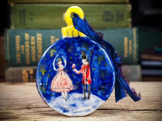 Handmade ceramic Nutcracker and ballerina ornament painted in blue and red by Idania Salcido aka Danita Art.