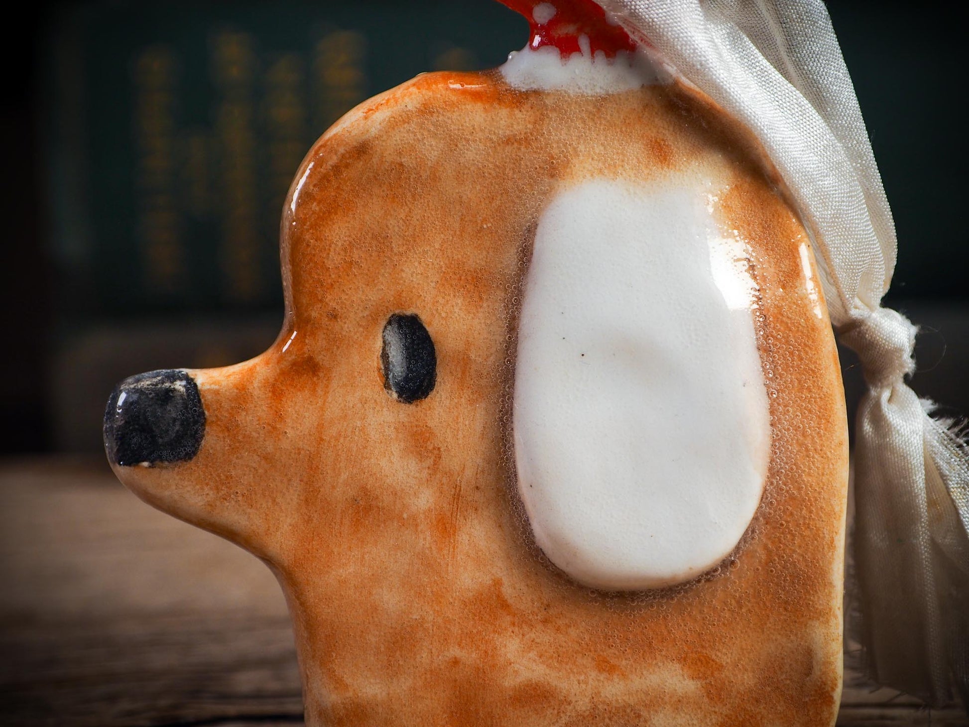 Handmade ceramic dog ornament with winter hoodie, created by Idania Salcido aka Danita Art for Christmas decorating or gifting.