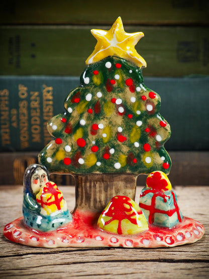 Handmade ceramic Christmas tree scene with child and gifts by Idania Salcido aka Danita Art.