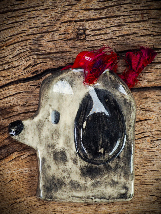 Handmade ceramic dog ornament with winter hoodie, created by Idania Salcido aka Danita Art for Christmas decorating or gifting.